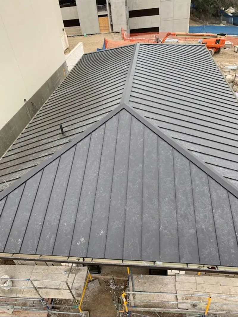 Commercial metal roof construction with crane equipment in Lumberton